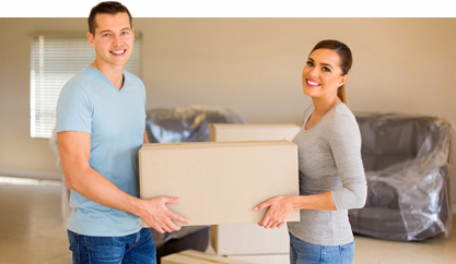 Smiling couple holding moving box